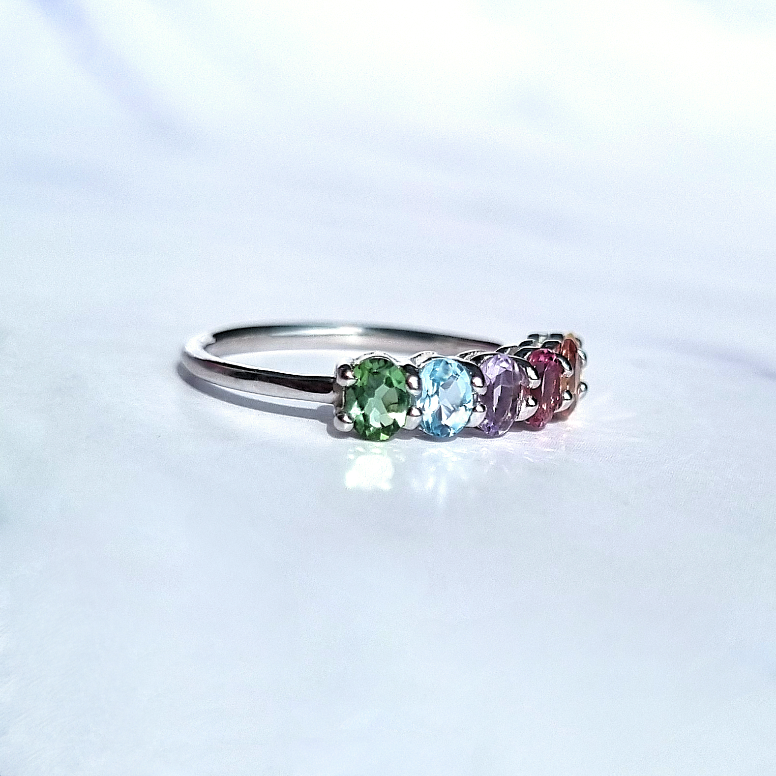 Rainbow multicoloured gemstone half eternity ring in sterling silver side view