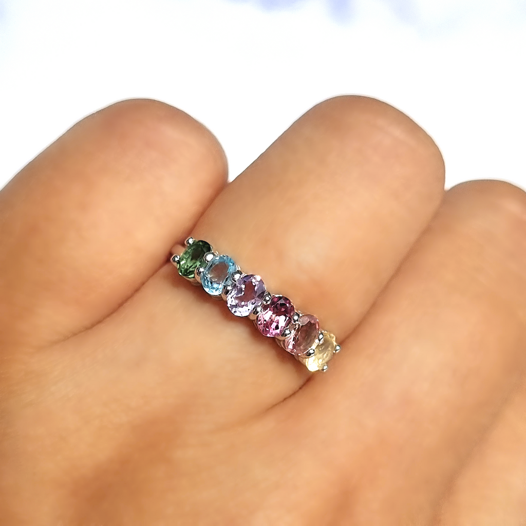 Rainbow multicoloured gemstone half eternity ring in sterling silver on hand