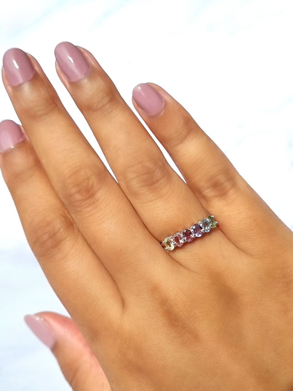 Rainbow multicoloured gemstone half eternity ring in sterling silver on hand detail image