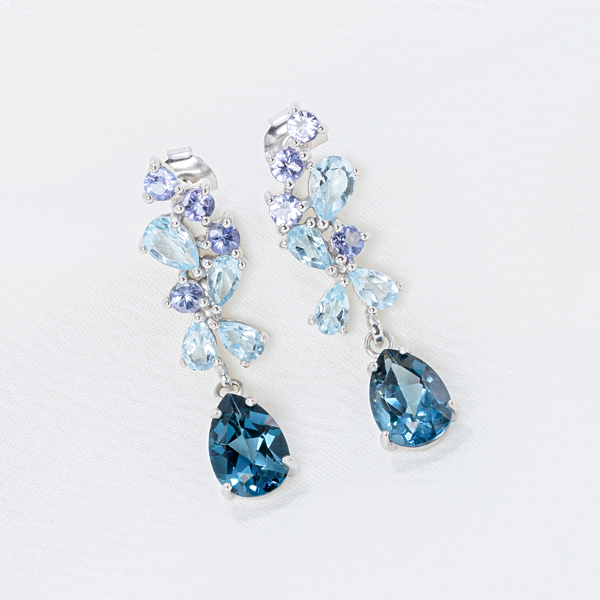 Blue gemstone drop earrings in sterling silver detail lifestyle image