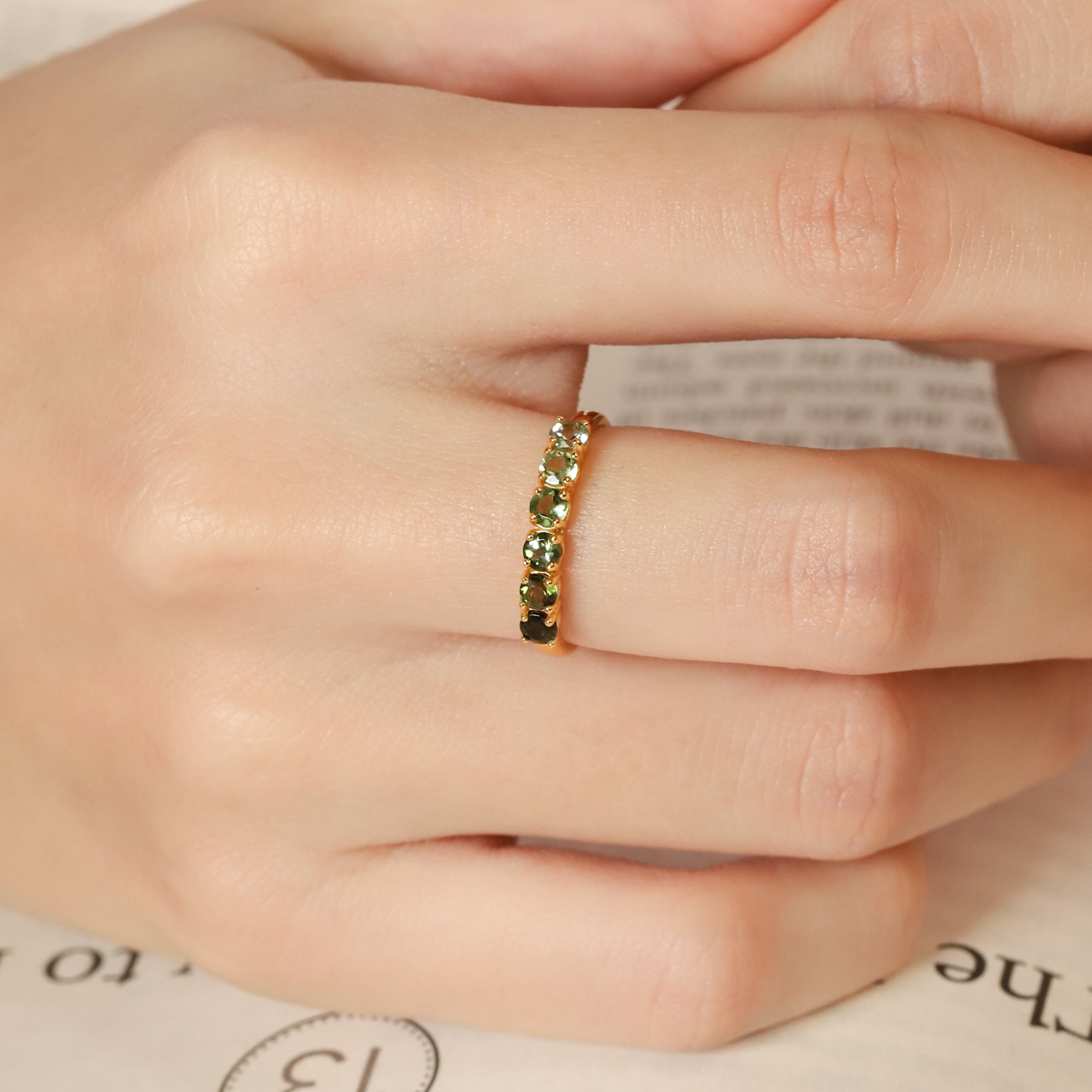 Ombre green tourmaline eternity band in 18k gold vermeil on hand