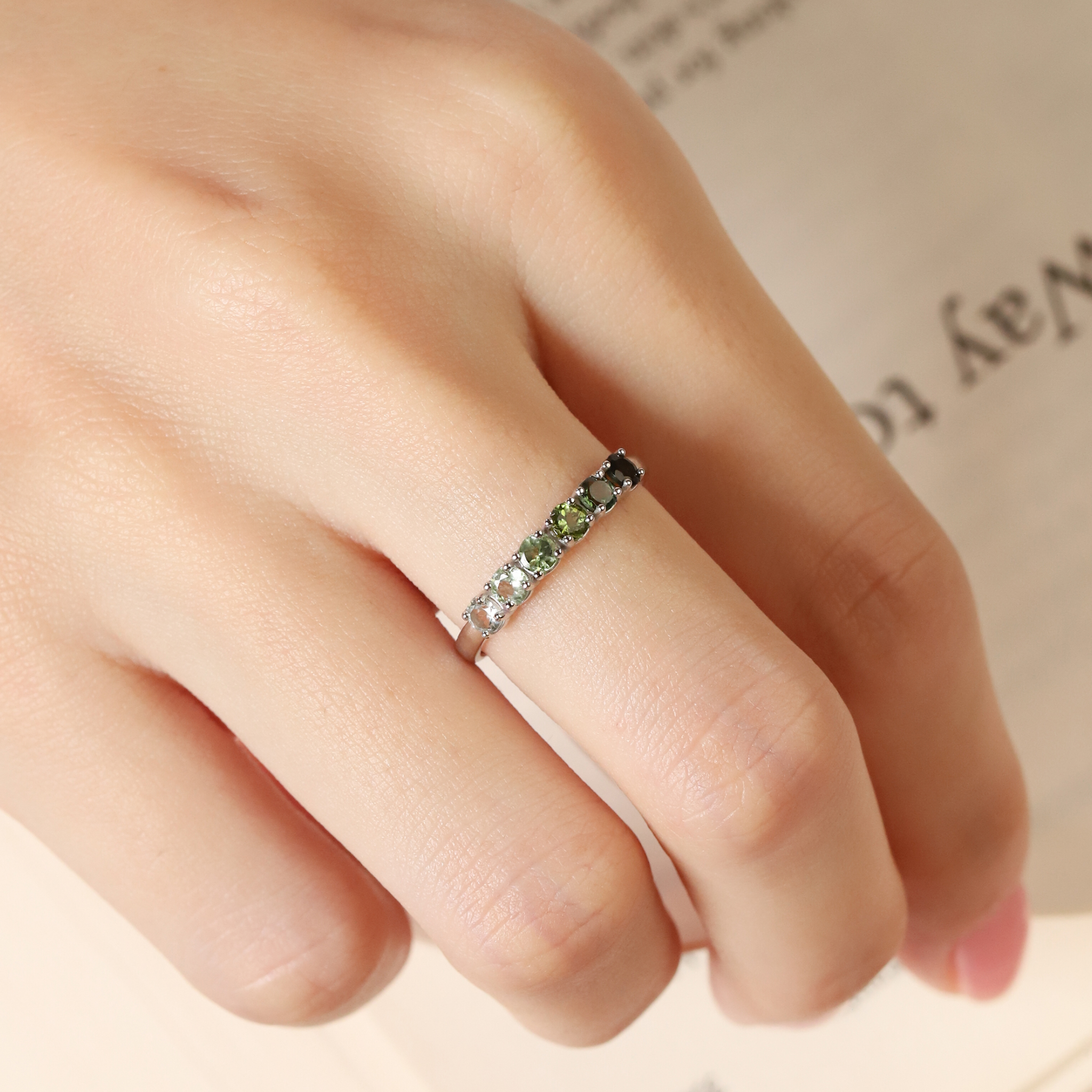 Ombre green tourmaline eternity band in sterling silver on hand