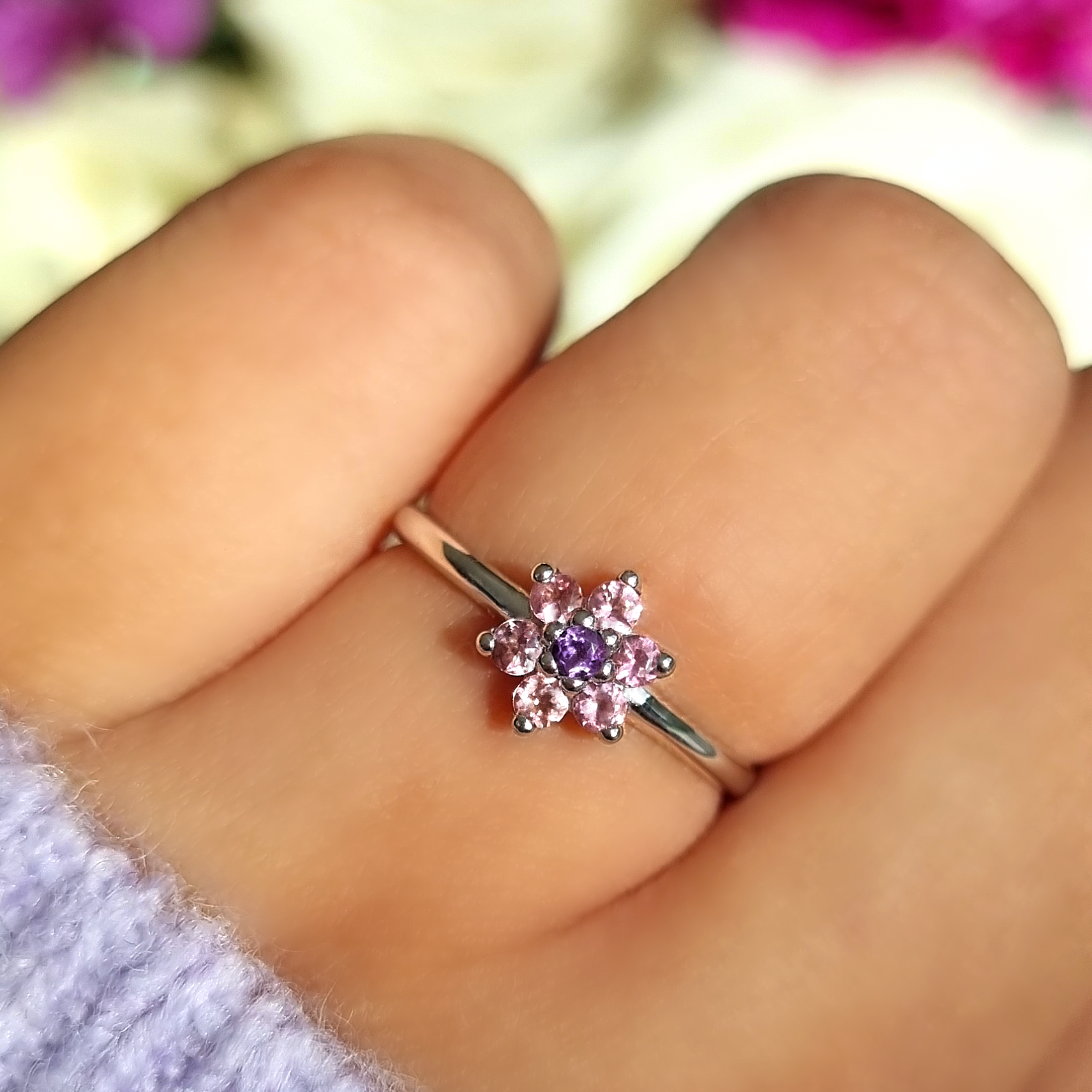 Pink tourmaline and amethyst flower ring in sterling silver on hand