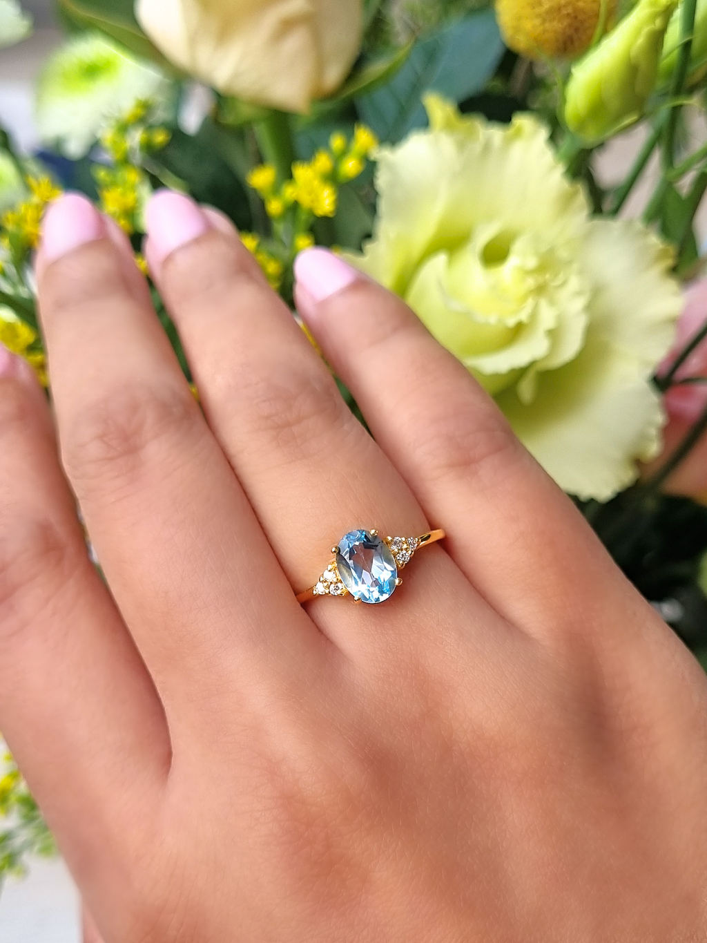 Sky blue topaz oval cut ring in 18k gold vermeil on hand detail image