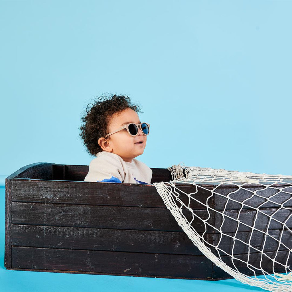 Babiators Eco Original Keyhole Soft Sand kids sunglasses worn outdoors