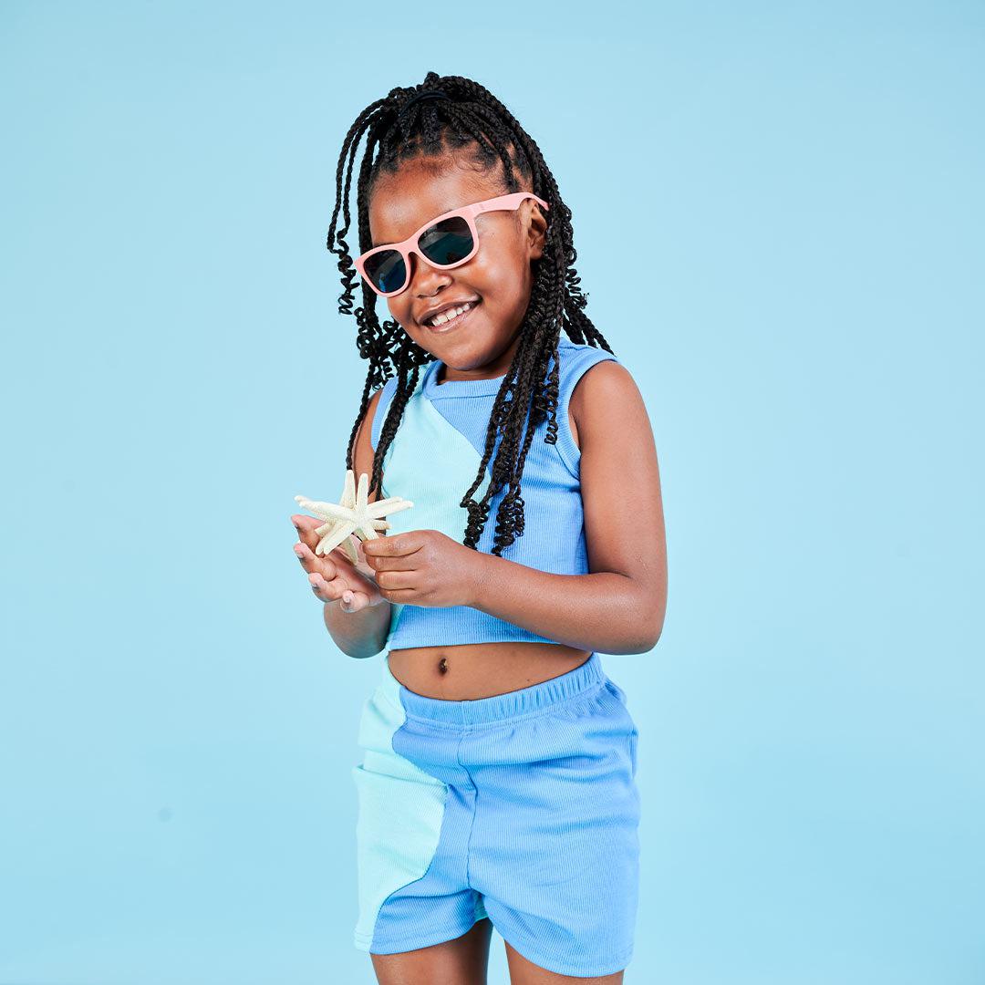 Babiators Eco Original Navigator Seashell Pink kids sunglasses worn outdoors