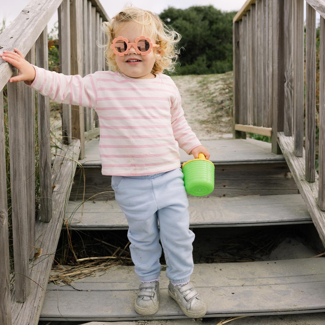 Babiators Polarised Flower Peachy Keen kids sunglasses worn outdoors