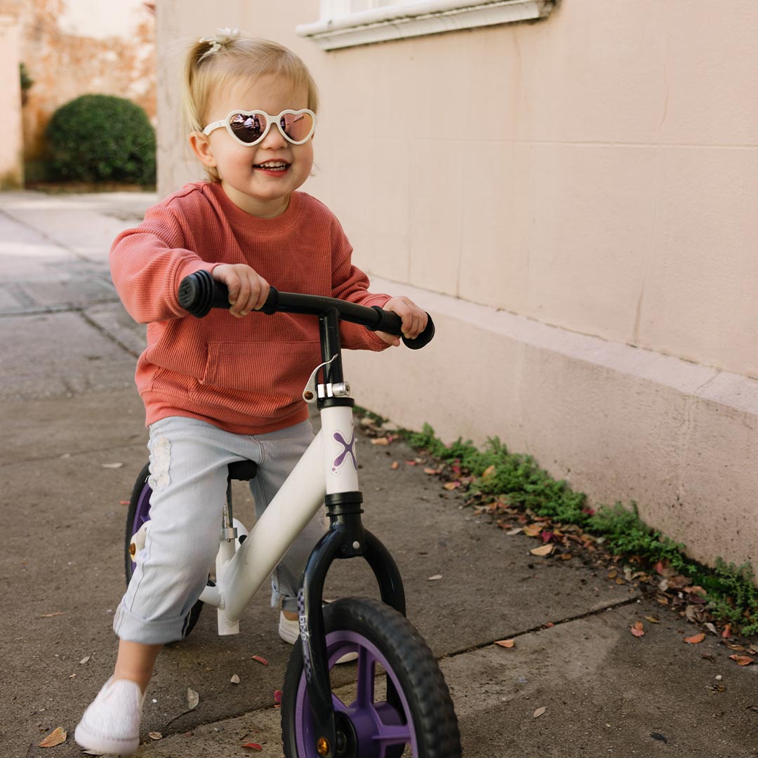 Babiators Polarised Heart Sweet Cream kids sunglasses worn outdoors