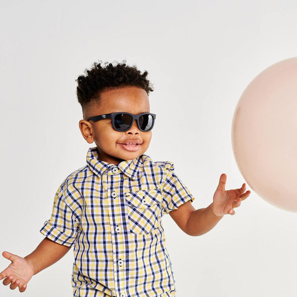 Babiators Polarised Navigator Jet Black Smoke kids sunglasses worn outdoors