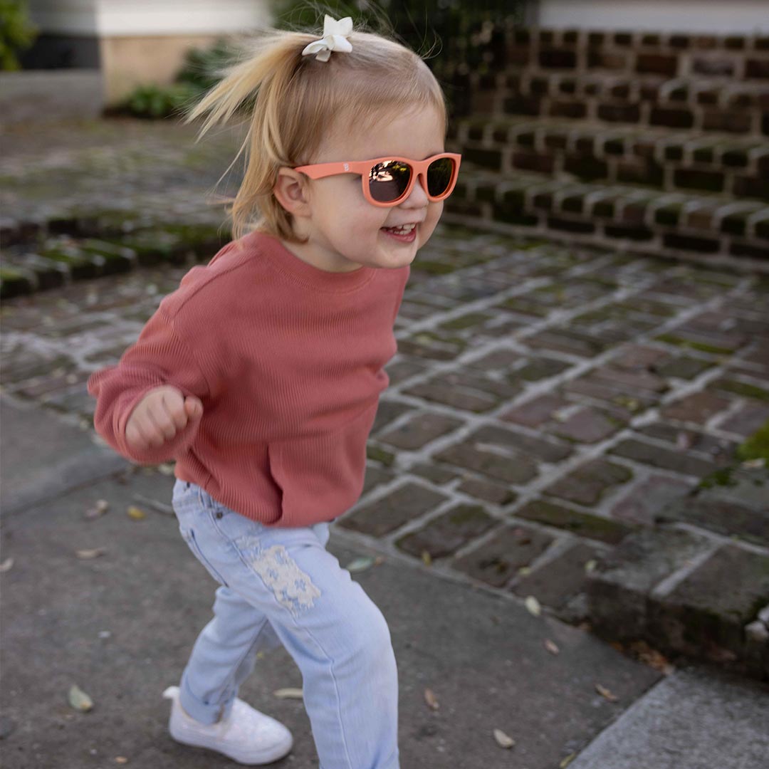 Babiators Polarised Navigator Perfectly Papaya kids sunglasses worn outdoors