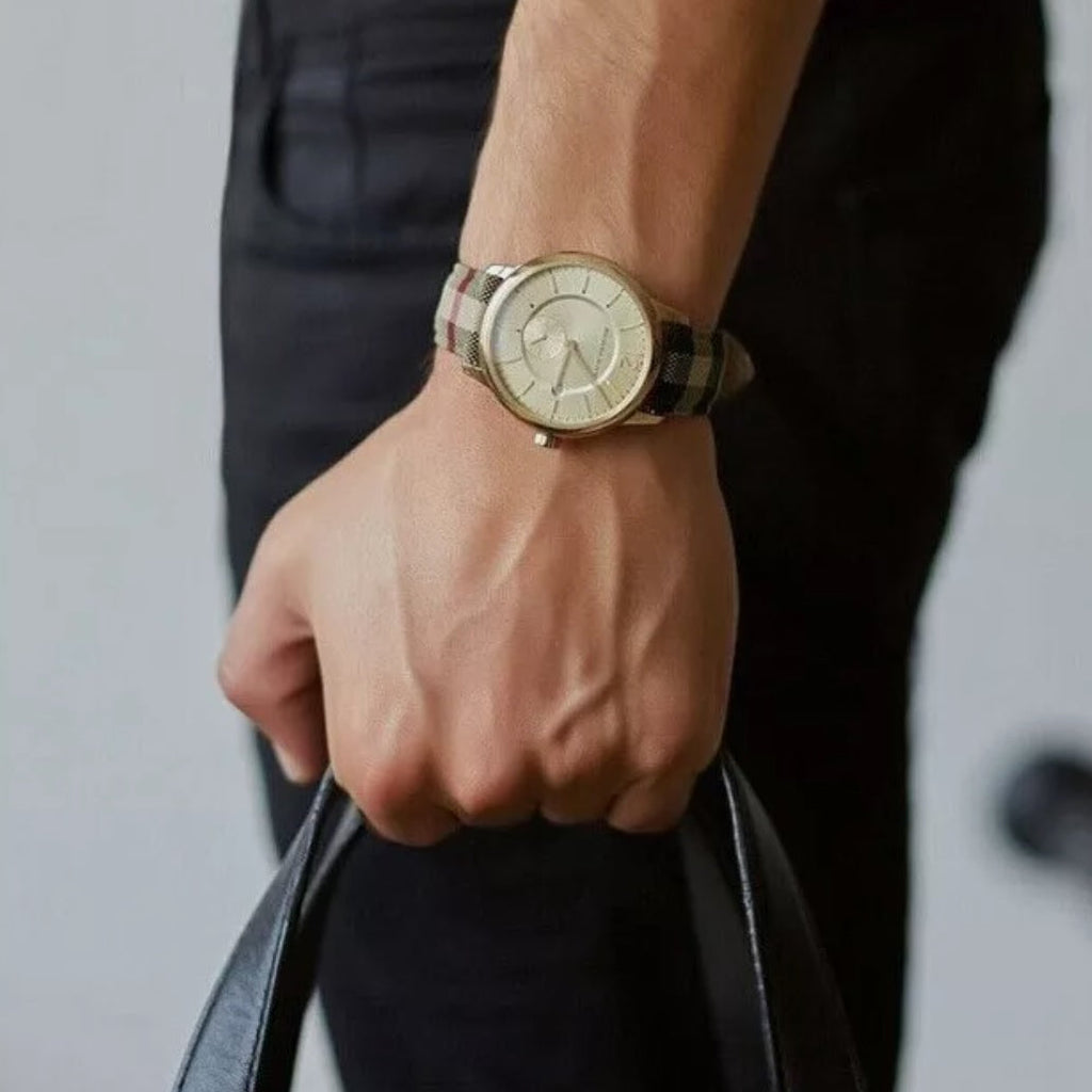Burberry BU10001 watch on wrist with multicolour strap and gold dial