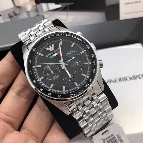 Emporio Armani AR5983 silver strap black dial watch held in hands