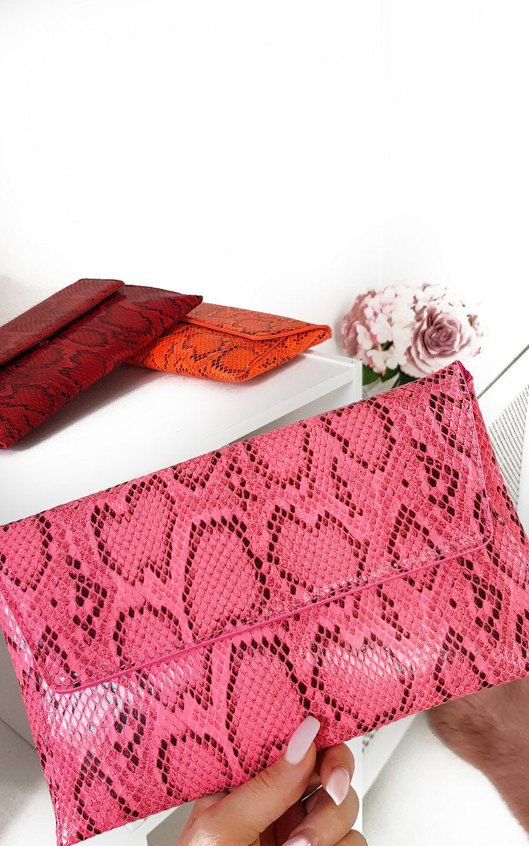 Kenike fuchsia snake print envelope clutch bag front view