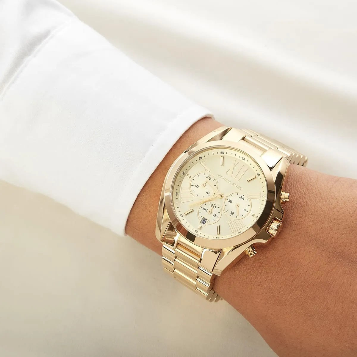 Michael Kors MK5605 gold watch on wrist close-up