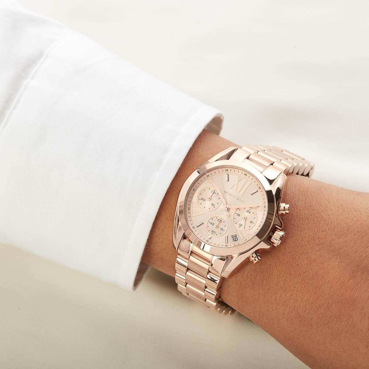 Michael Kors MK5799 Bradshaw rose gold watch on wrist close-up