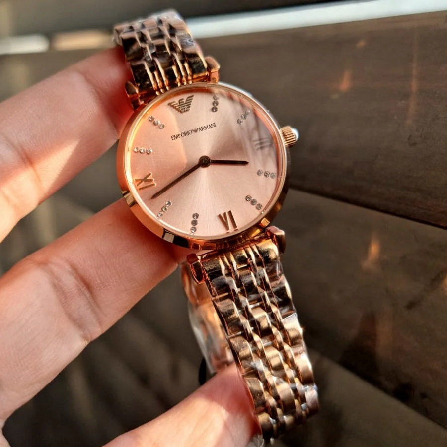 Emporio Armani AR11059 rose gold watch held in hands