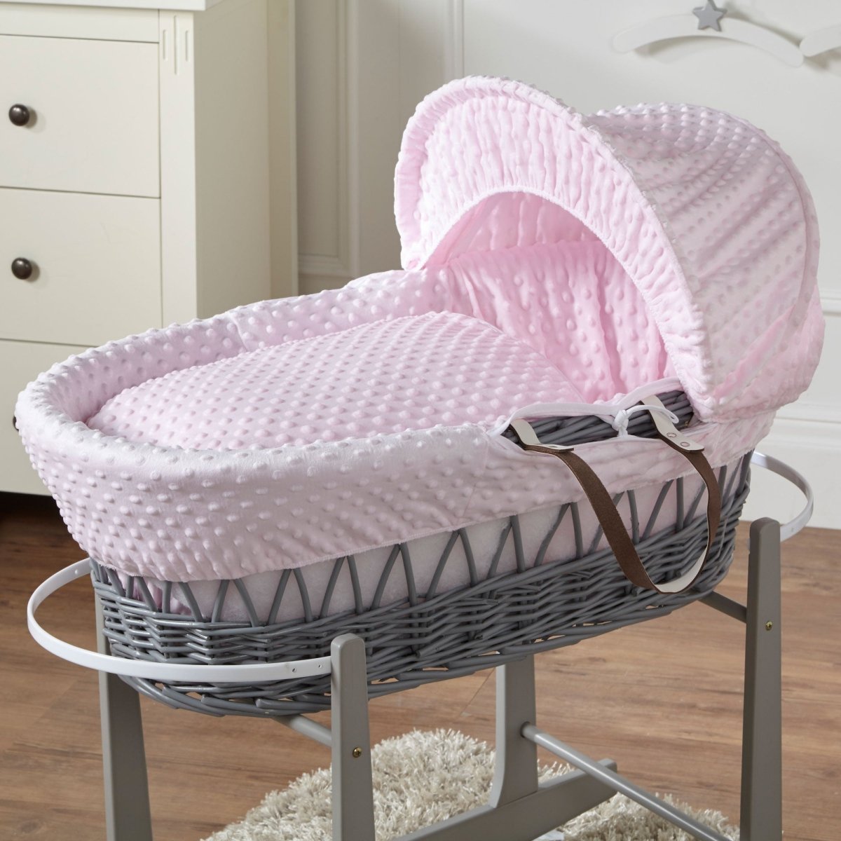 Pink dimple grey wicker baby Moses basket with stand side view
