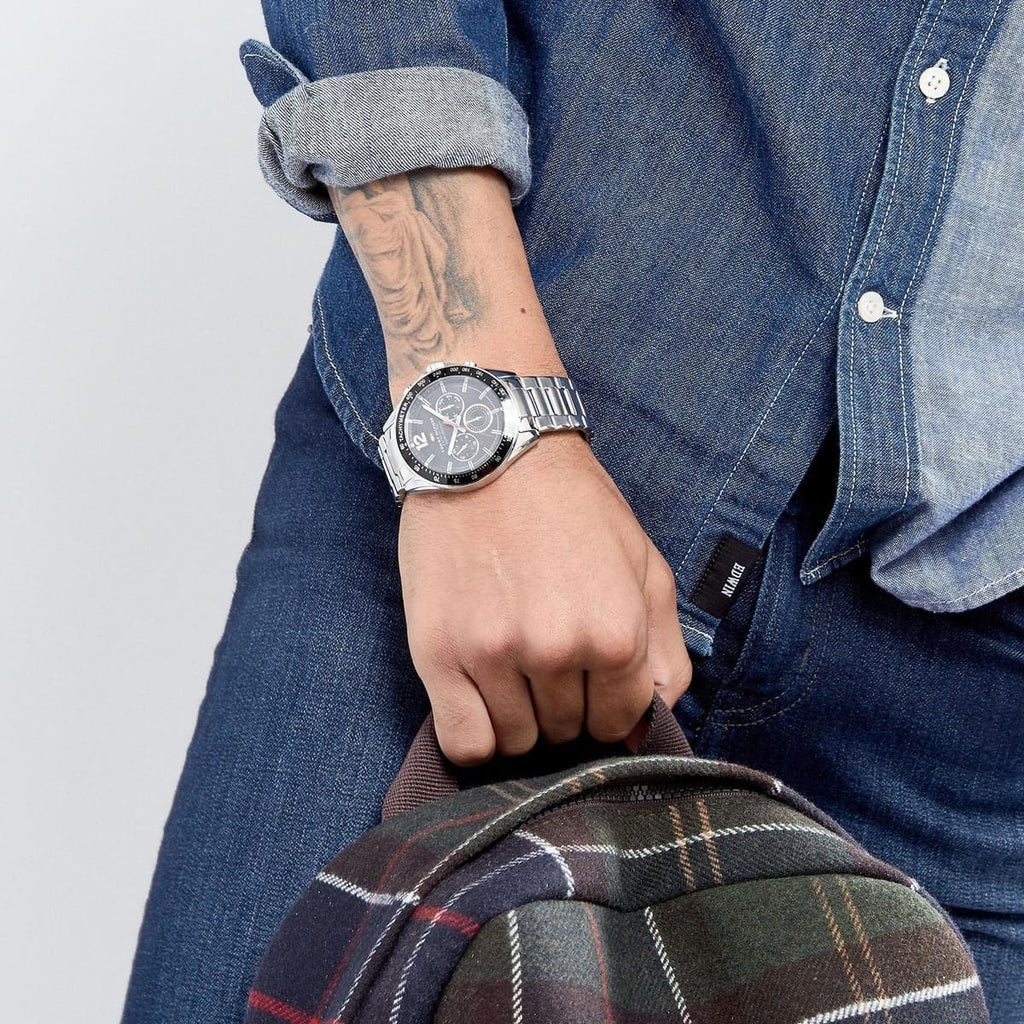 Tommy Hilfiger 1791104 Luke watch on wrist with black dial and silver bracelet